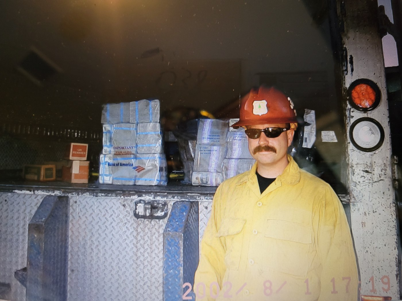 Michael McNeil in wildland gear at a fire engine, 2002